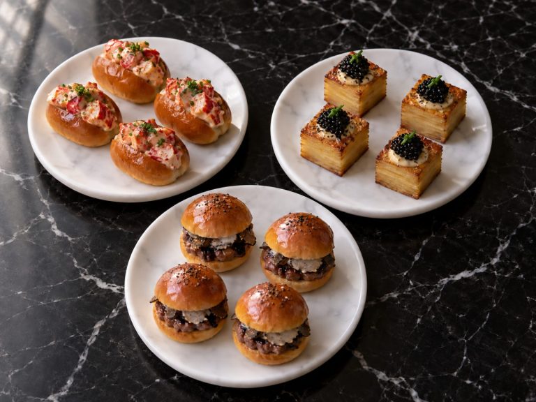Lobster brioche bites, caviar potato pavé and wagyu sliders on three white plates