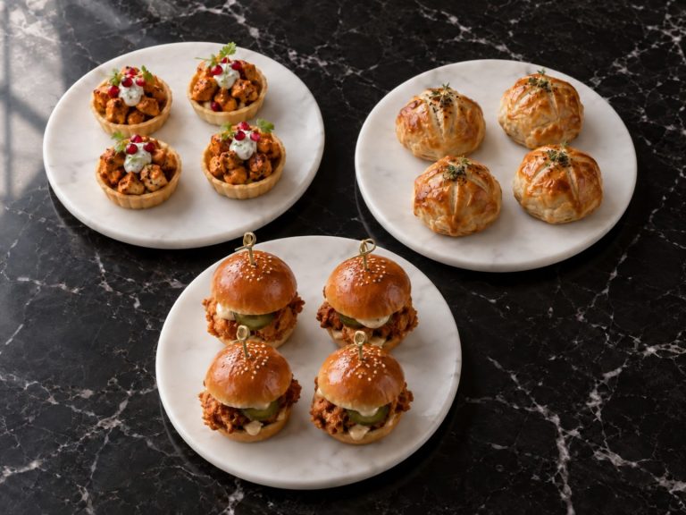 Chicken tikka tartlets, enclosed beef Wellingtons and fried chicken sliders on three white plates