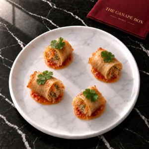 Four portions of Vegan Spring Roll with Sweet Chilli on a white marble plate