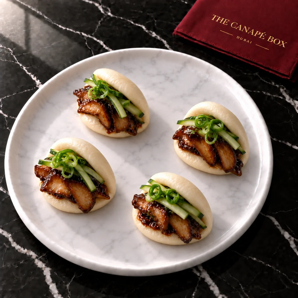 Four portions of King Oyster Mushroom Bao on a white marble plate