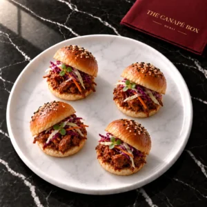 Four portions of Mini Jackfruit Slider with Slaw on a white marble plate