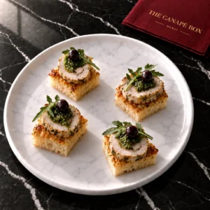 Four portions of Lemon-Herb Chicken Roulade on Focaccia on a white marble plate
