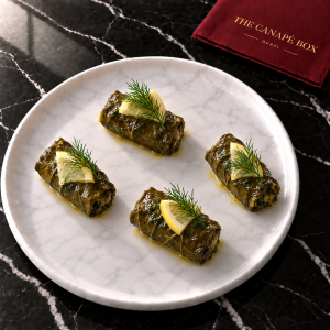 Four portions of Stuffed Vine Leaf Mini on a white marble plate