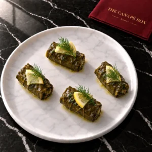 Four portions of Stuffed Vine Leaf Mini on a white marble plate