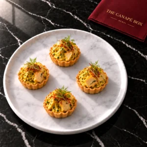 Four portions of Chicken & Saffron on a white marble plate