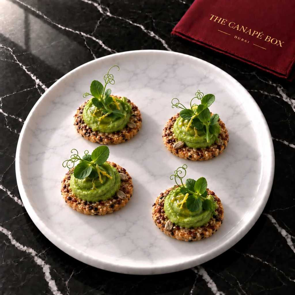 Four portions of Green Pea & Mint on Seed Cracker on a white marble plate