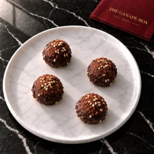 Four portions of Date & Tahini Truffle on a white marble plate