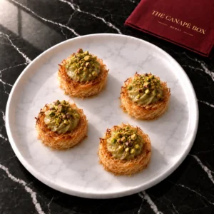 Four portions of Mini Kunafa with Pistachio Cream on a white marble plate