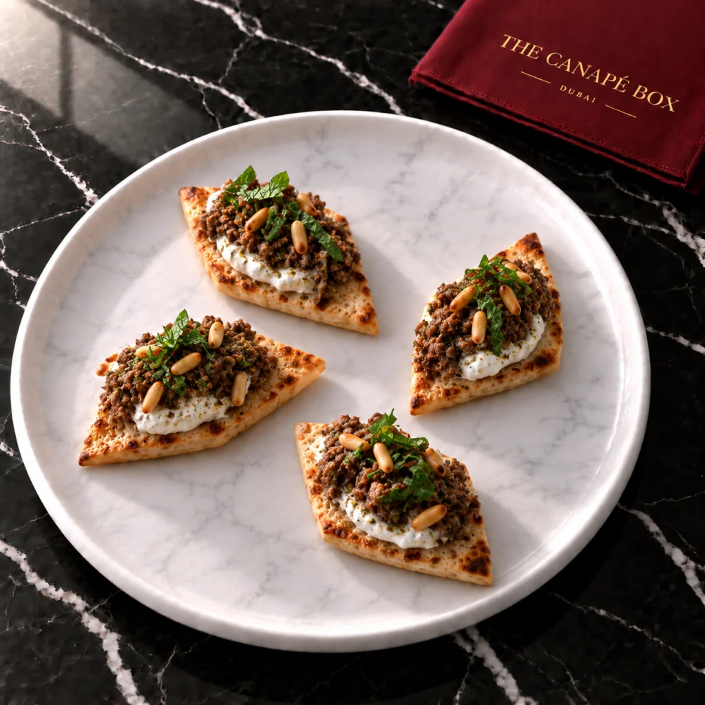 Four portions of Za'atar Lamb Flatbread Diamond on a white marble plate