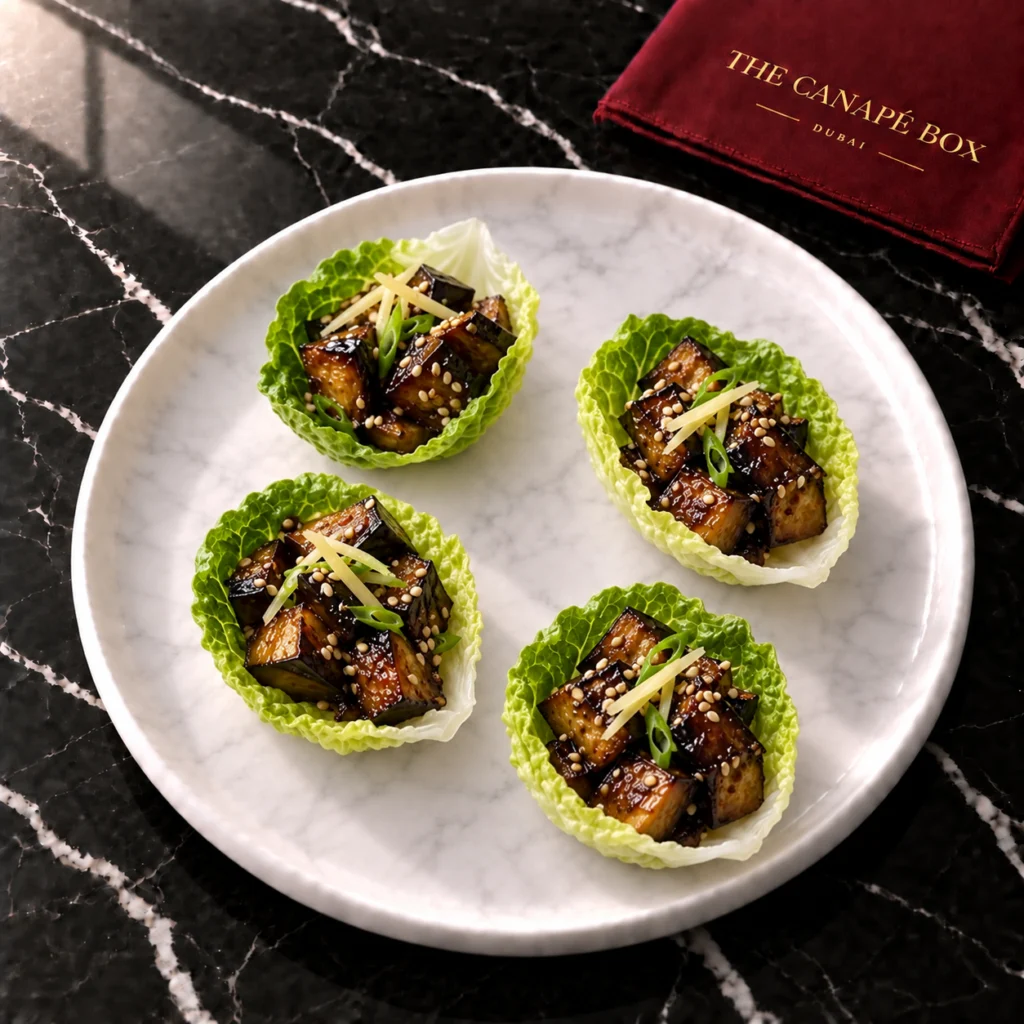 Four portions of Miso Aubergine Cup (Nasu Style) on a white marble plate
