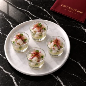 Four portions of Sea Bass Ceviche Cup on a white marble plate