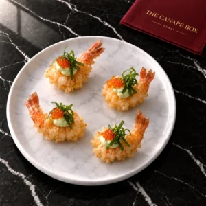 Four portions of Tempura Prawn with Wasabi Mayo on a white marble plate
