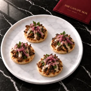 Four portions of Mushroom Shawarma Mini Flatbread on a white marble plate