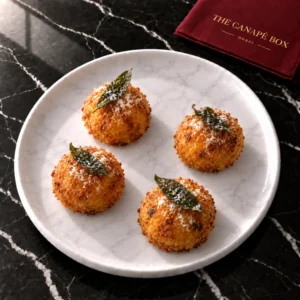 Four portions of Pumpkin & Sage Risotto Ball on a white marble plate