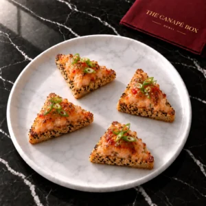 Four portions of Sesame Prawn Toast on a white marble plate
