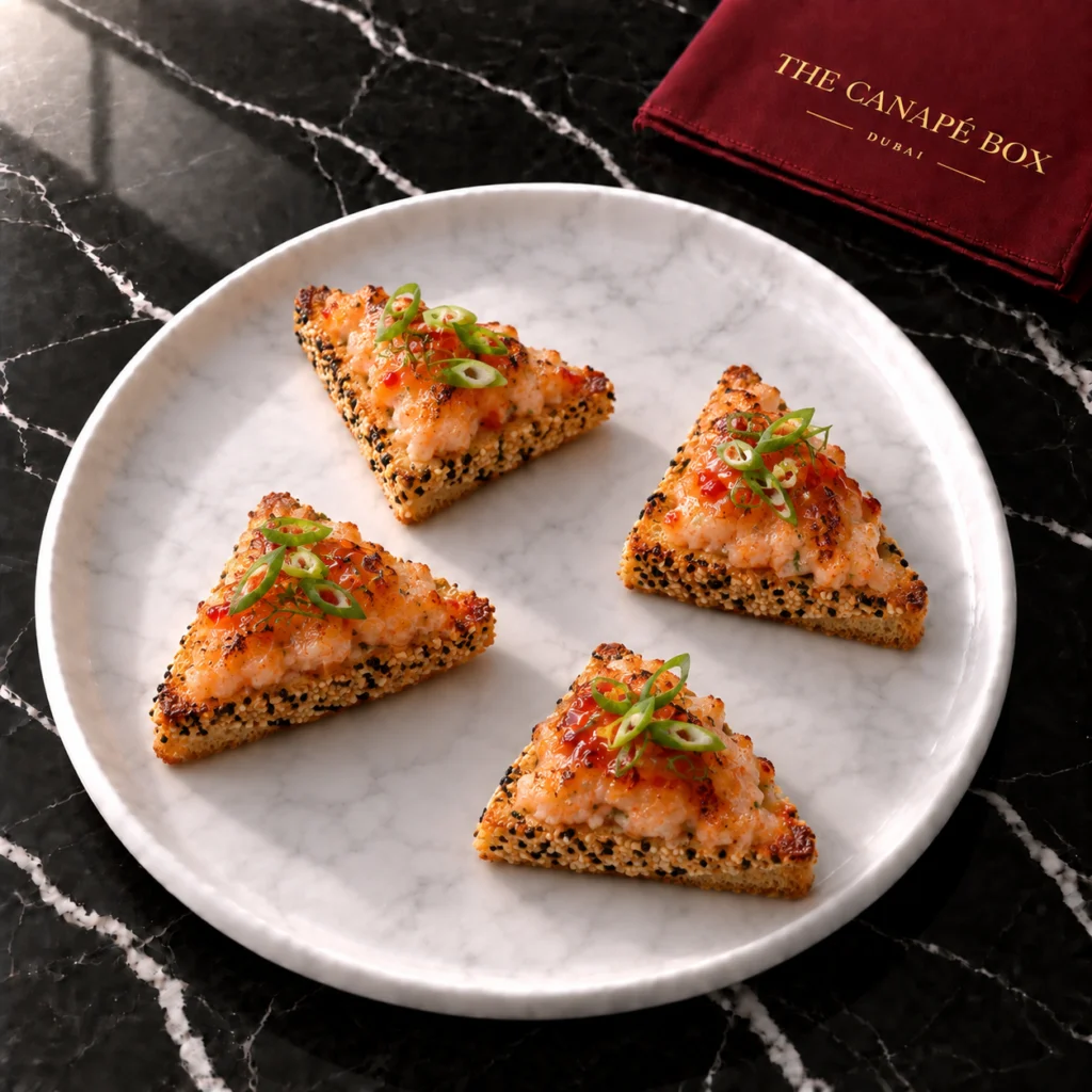 Four portions of Sesame Prawn Toast on a white marble plate