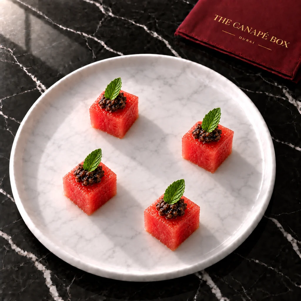 Four portions of Watermelon & Olive Jewel on a white marble plate