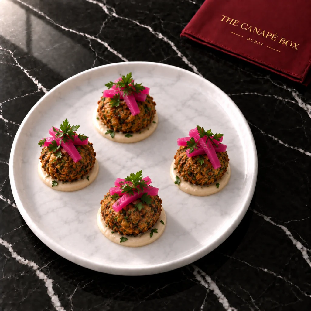 Four portions of Falafel Bite with Tahini & Pickled Turnip on a white marble plate