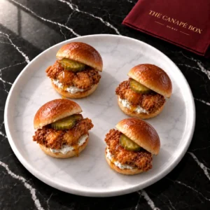 Four portions of Buttermilk Fried Chicken Mini Slider on a white marble plate