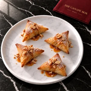 Four portions of Moroccan Chicken Briouat on a white marble plate