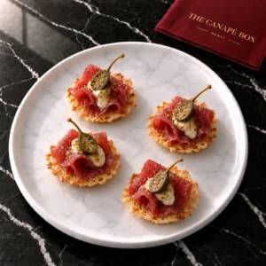 Four portions of Beef Carpaccio Crisp on a white marble plate