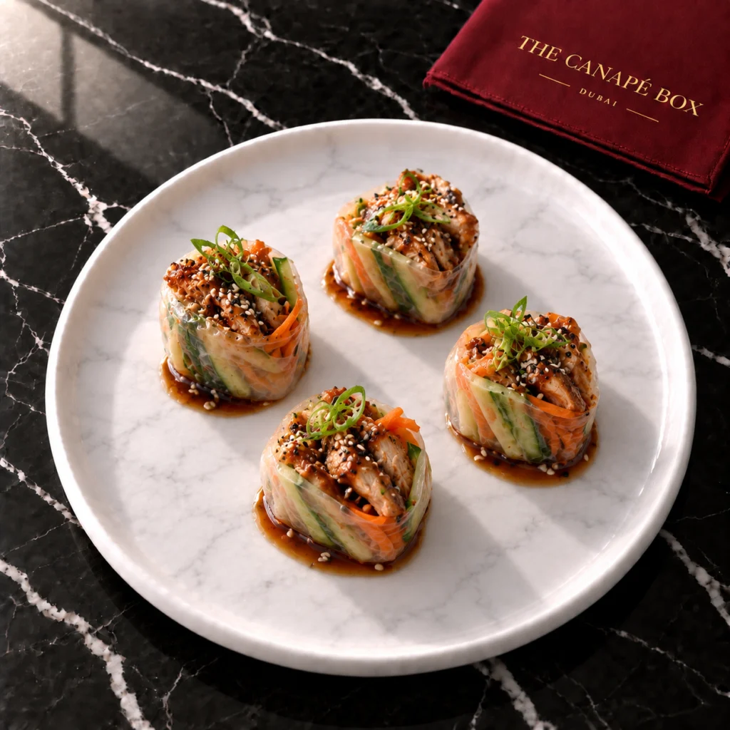 Four portions of Teriyaki Chicken Rice Paper Roll on a white marble plate