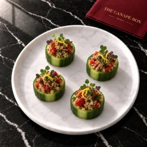 Four portions of Quinoa & Roast Pepper Cucumber Cup on a white marble plate